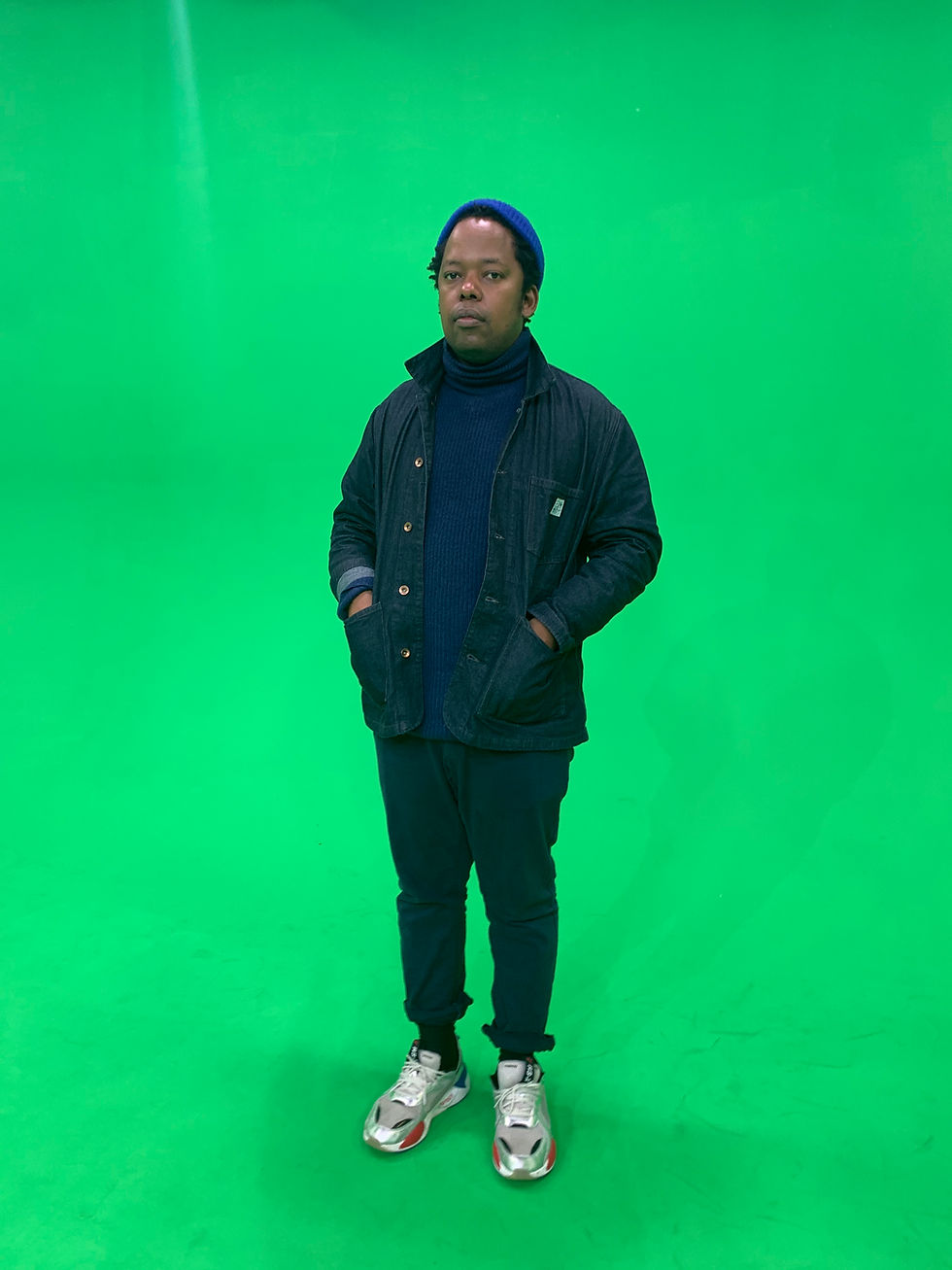 Mo Laudi, South African Afro house DJ and producer, against a green background