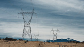High tension power lines under a cloudy sky
