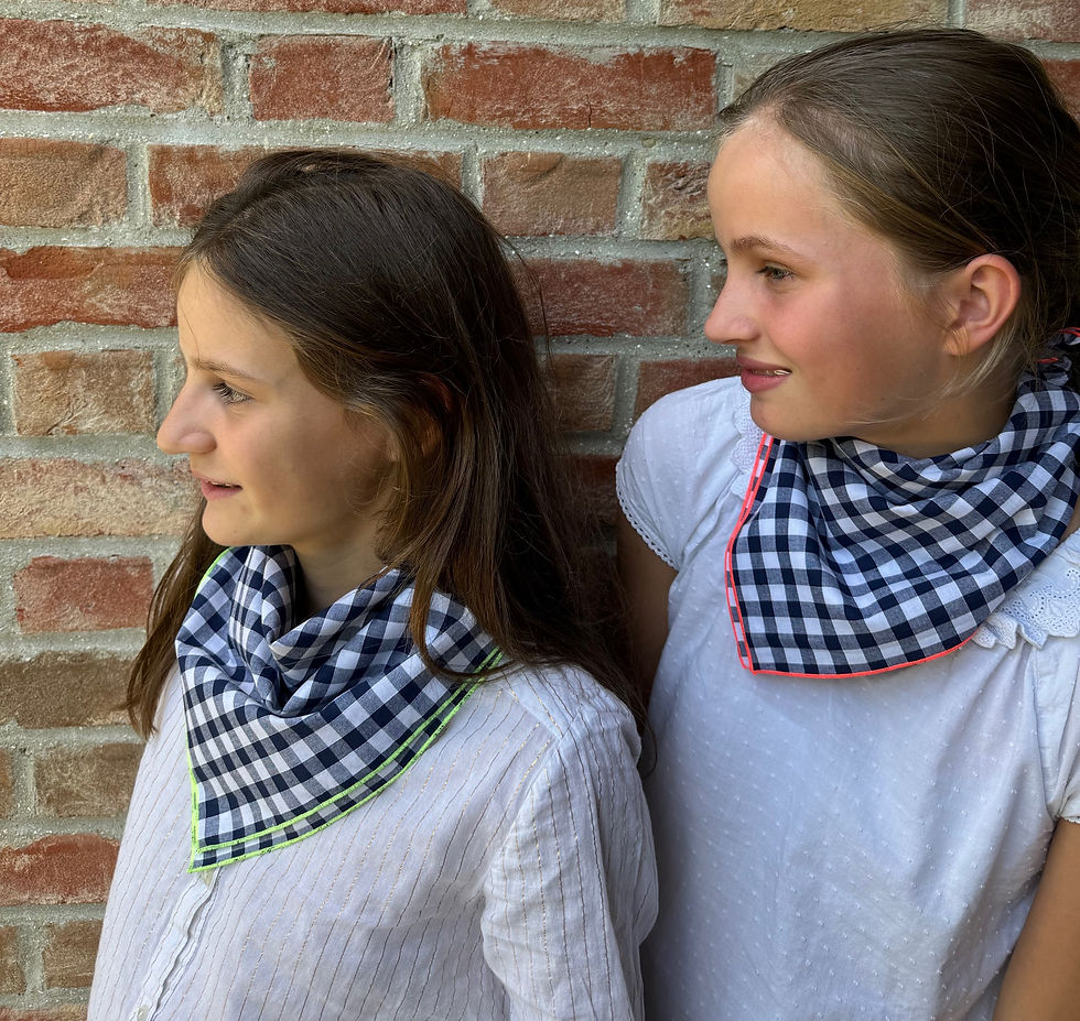 Close-up view of a child wearing a red bandana tied around the neck