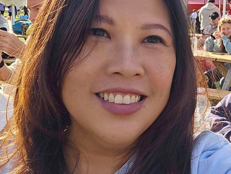 Natalia smiles brightly while enjoying a sunny day outdoors, filled with optimism about the future.