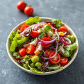 Fresh salad with cherry tomatoes, red onion, and greens
