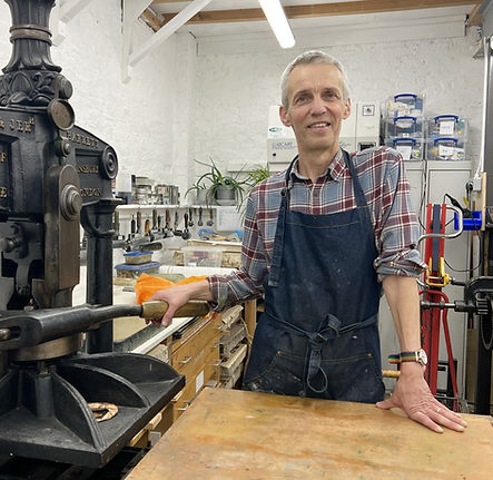 J. R. Bateson, painter and printmaker, pictured at his printing press in his studio — member of Epiphany Art