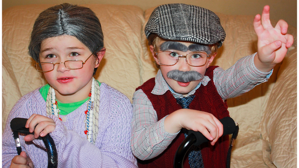 Two kids dressed up as an Old Granny and an Old Man for Halloween