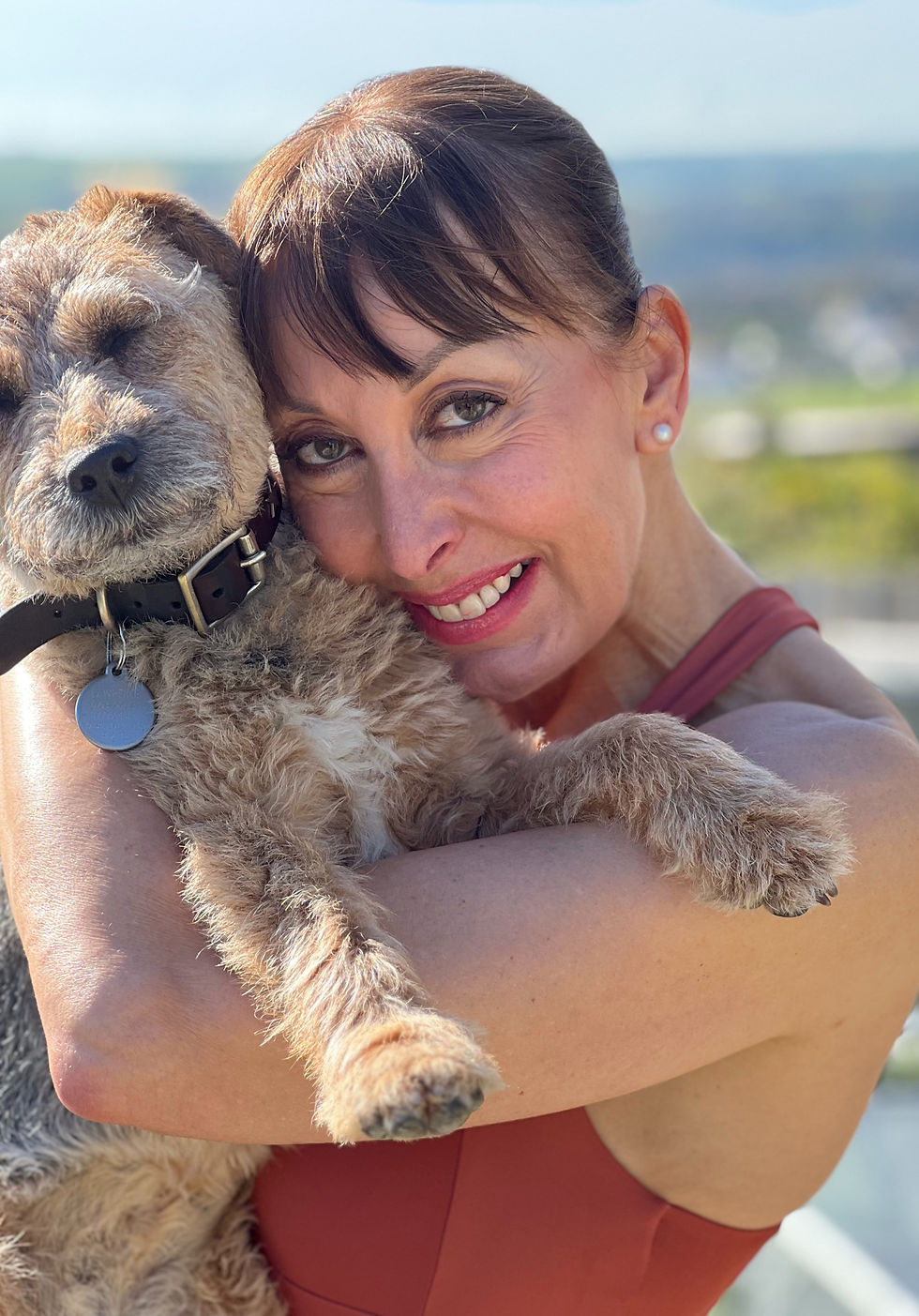 Rachel Lawrence hugging her pet dog
