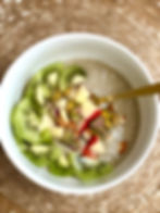 Chia seed pudding bowl with apple, kiwi fruit, pistachio and almond nuts