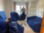 Furniture being covered for house removal with blue fabric