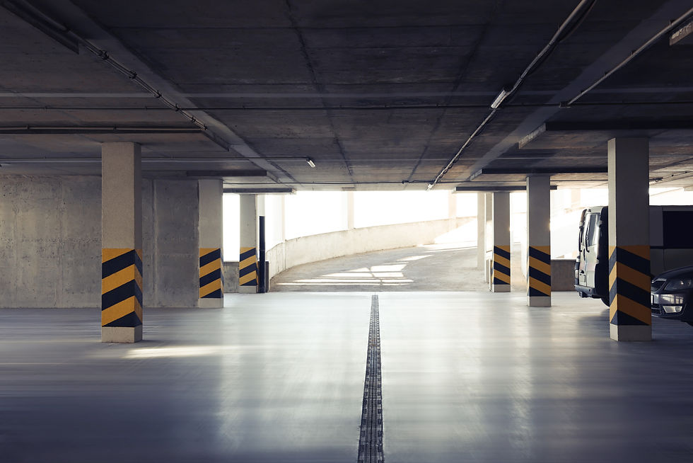 Open car parking garage with ramp on sunny day.jpg