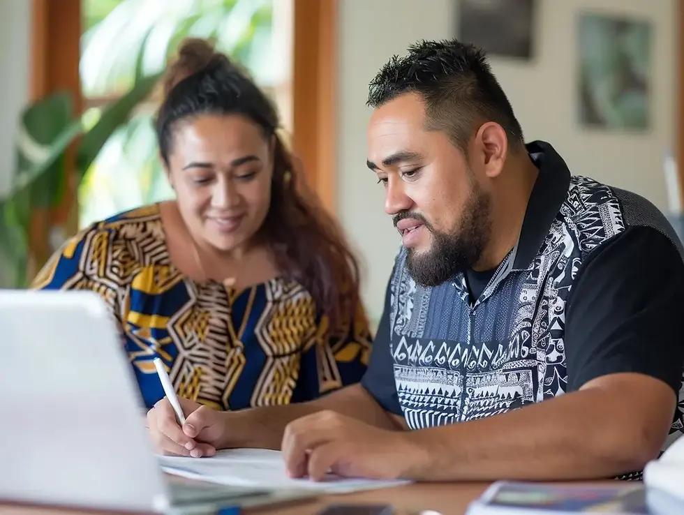 A man and woman are seated at a table, looking at a document together, suggesting they are working collaboratively