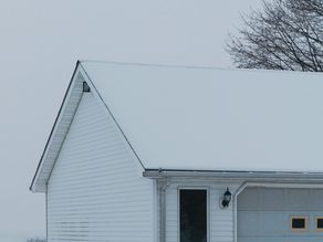 House roof covered in snow and frost in winter