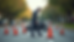 Eye-level view of a motorcycle accident scene on a suburban road with emergency cones placed around