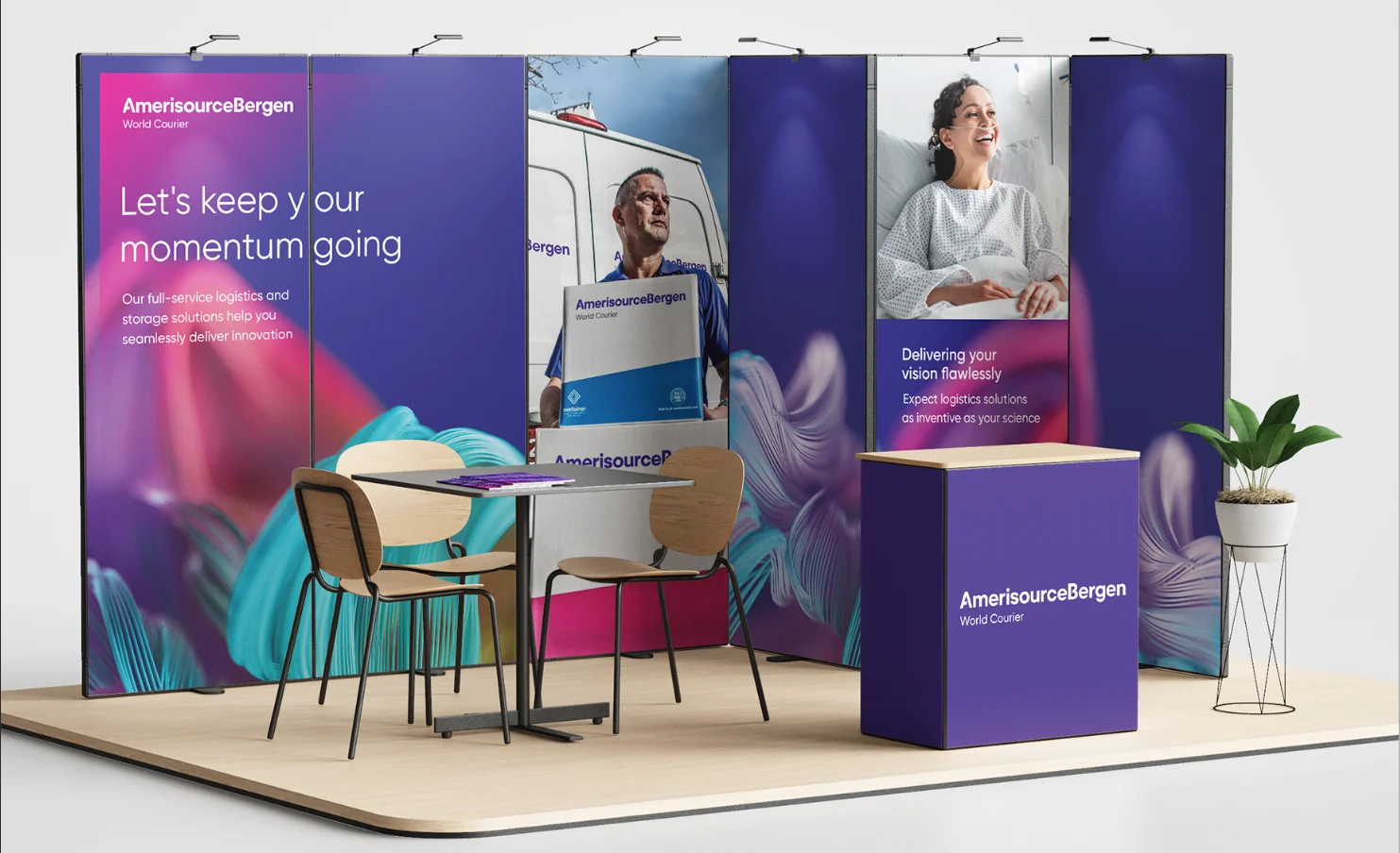 Event display with backwall graphics, table and chairs, and a greeter booth