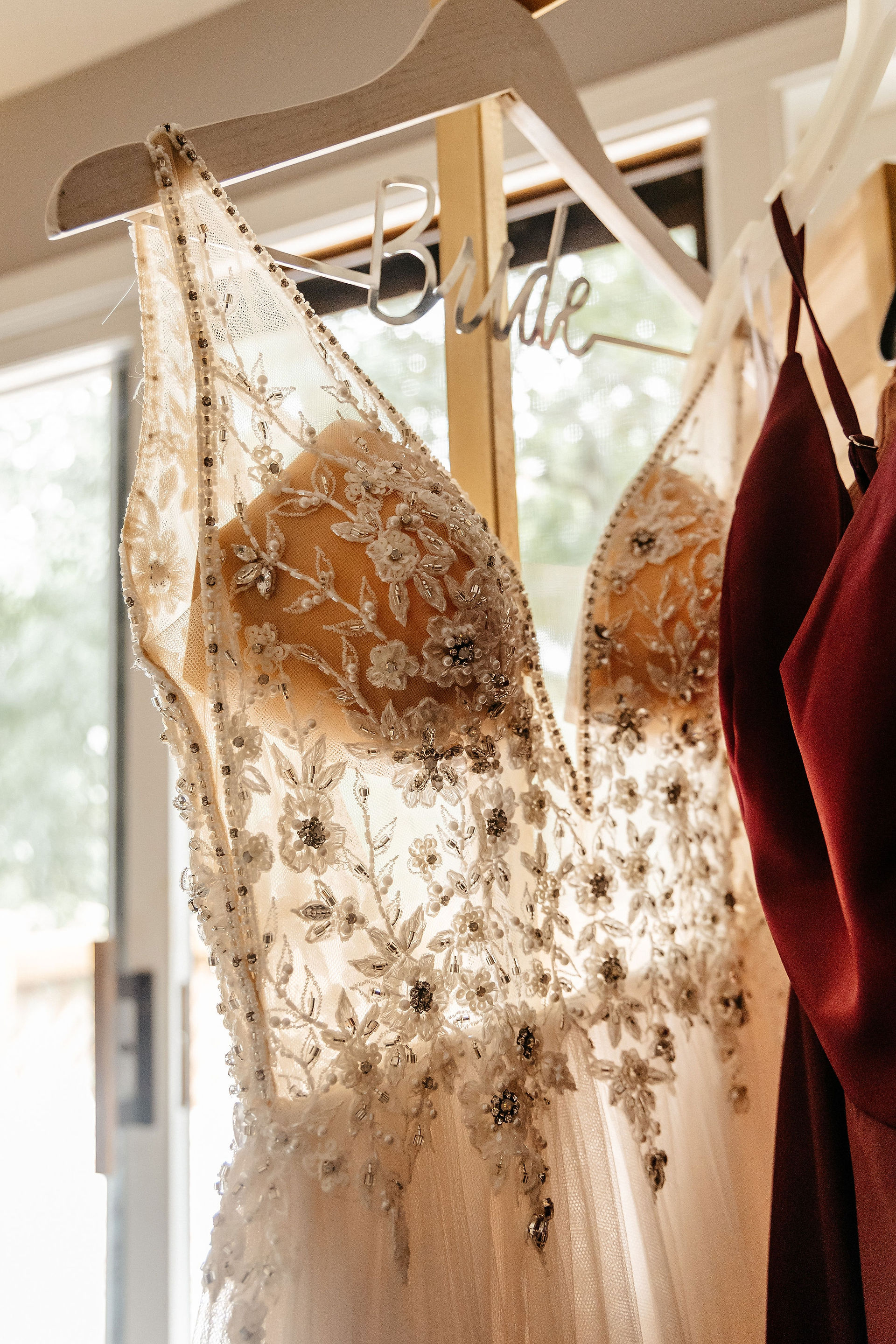 Wedding dress hanging in the window on the wedding day.