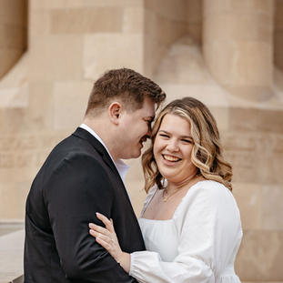 An engaged couple standing together for the photo.