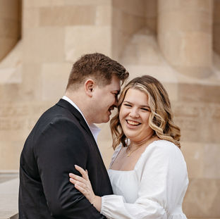 An engaged couple standing together for the photo.