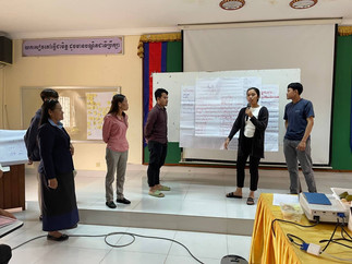 Female Cambodian teacher present holding microphone duirng training
