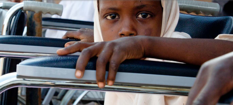 Image of girl looking at camera sitting in wheelchair