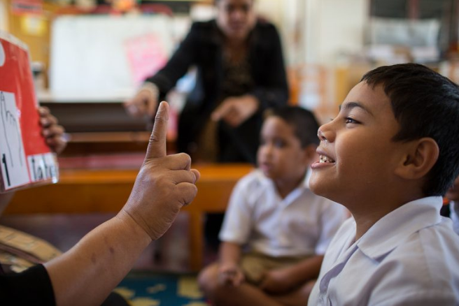Child smiling looking at teacher