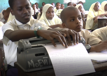 photo of child reading braille