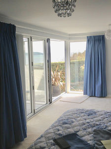 open blue curtains in the corner of a lounge