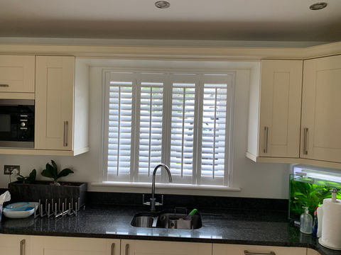 shutter blinds behind kitchen sink
