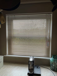 A kitchen window with a new Venetian blind