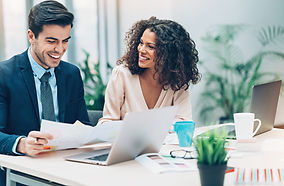 business meeting, a man is checking documents with a female colleague