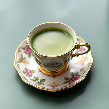 antique tea cup and saucer with green matcha tea in it.jpg