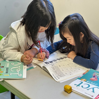 Students having fun writing in Chinese