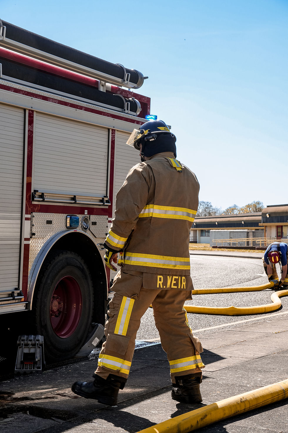 USAF FIREFIGHTER NEXT TO APPLIANCE