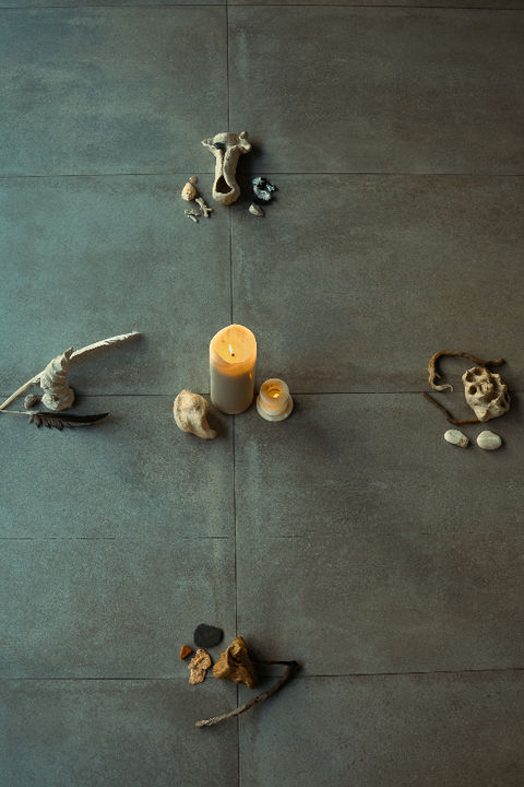 Von oben fotografierte Kerze, umgeben von Naturmaterialien, die in vier Richtungen wie ein Kompass angeordnet sind und die vier Elemente darstellen – bei einem Retreat oder einer 1:1 Sitzung von Kailo Nature Therapy.