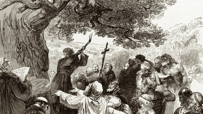 Boniface cuts down the Donar oak tree with people gathering around him