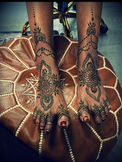 This is a picture of henna a woman got done for a wedding. The henna starts at the toes and goes to the mid calf. The henna is very traditional style with floral and chandelier elements.