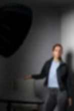Close-up of a camera on a tripod in a bright studio