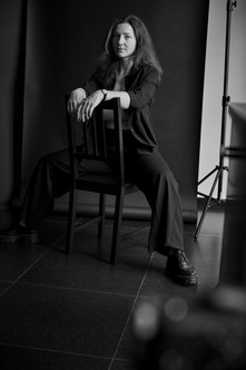 Woman in black pantsuit, powerful pose