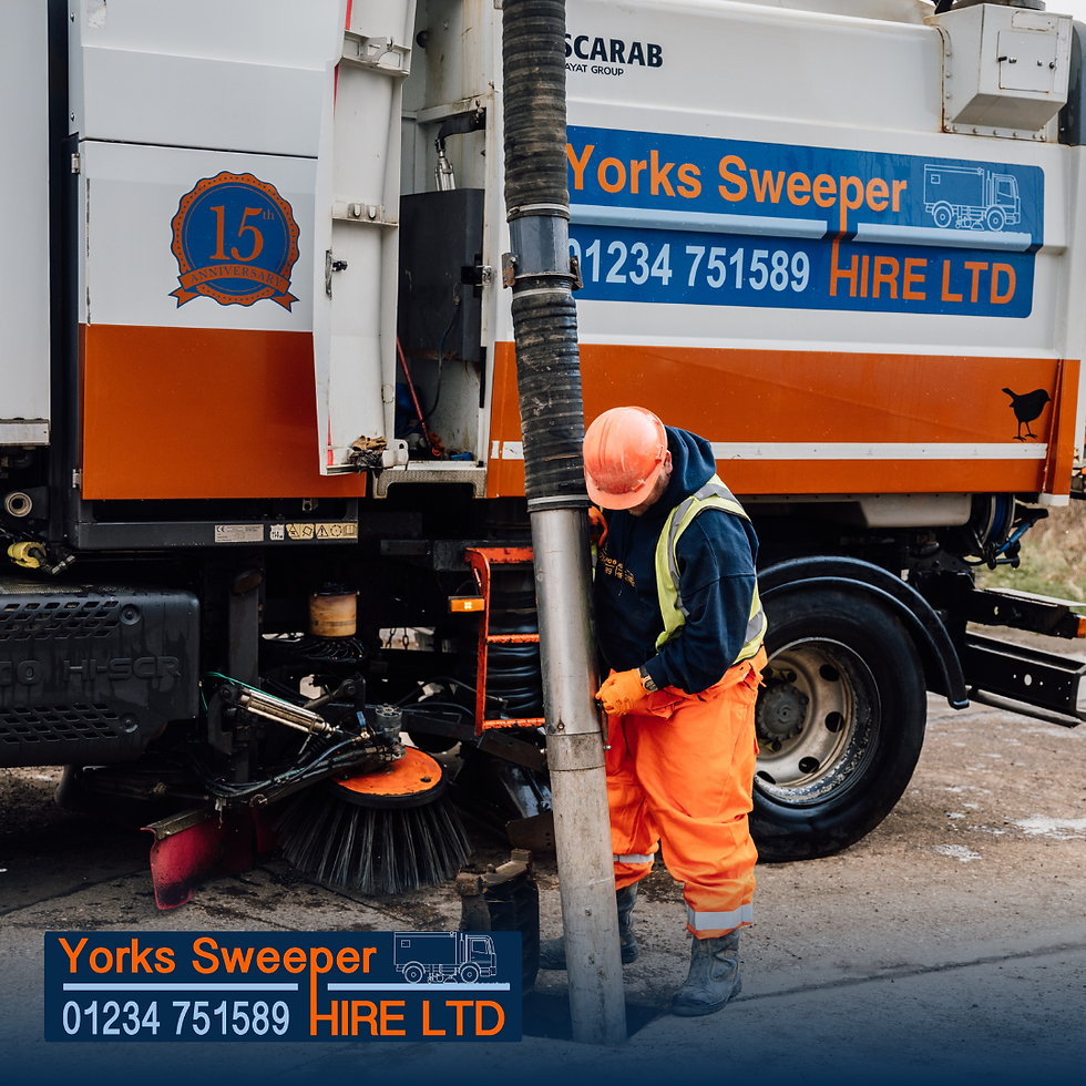 Worker in orange gear operates a road sweeper with "Yorks Sweeper Hire LTD" signage. The vehicle is white and orange.