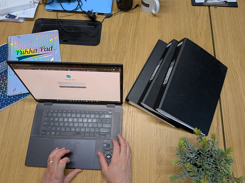 Bookkeeper organising financial records for a small business in Northampton.