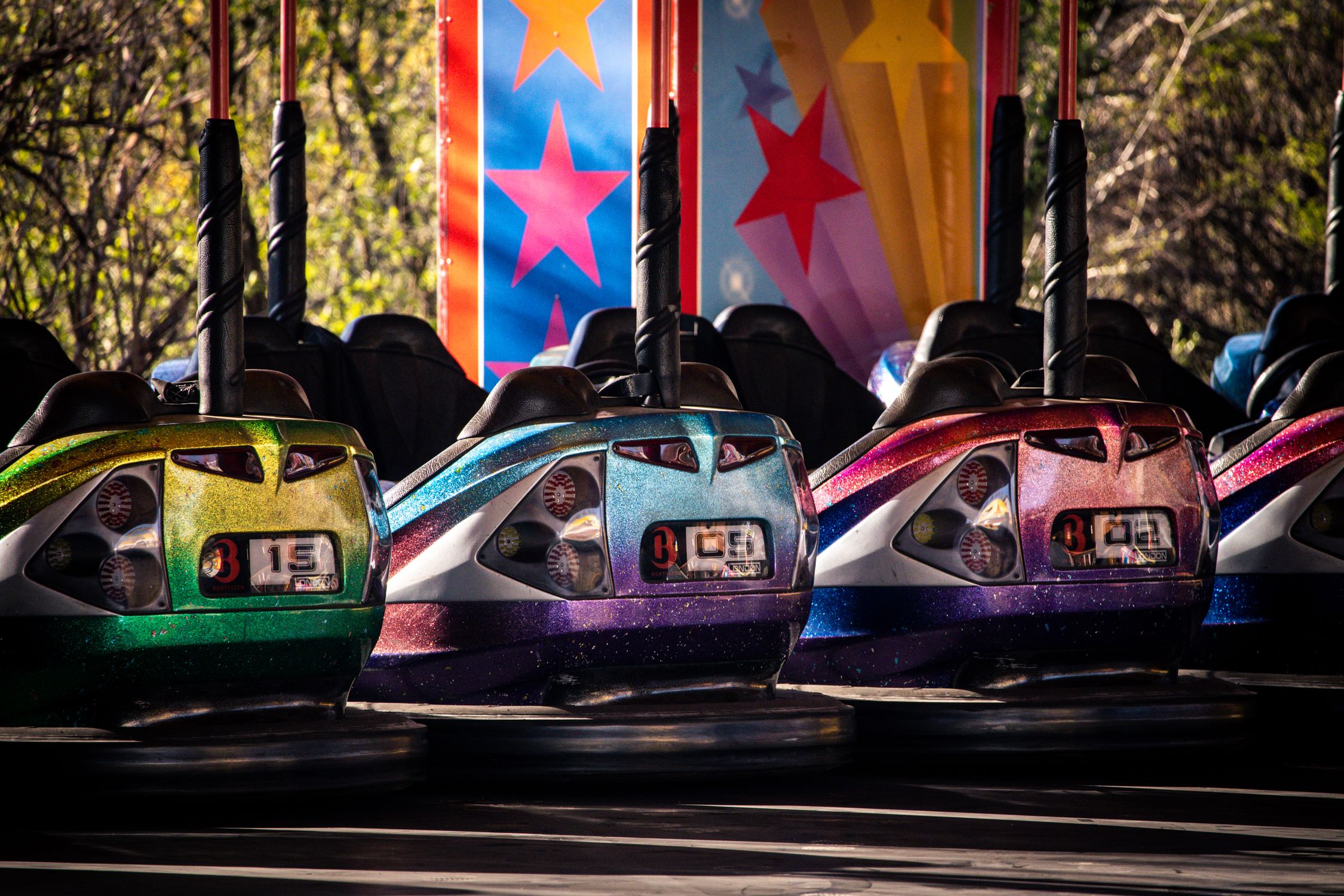 Illustrative photograph of unoccupied bumper cars at an amusement attraction. Not an exact model offered for sale.