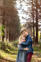 A boy and a girl, Siblings hug in a forest area for Family Photos