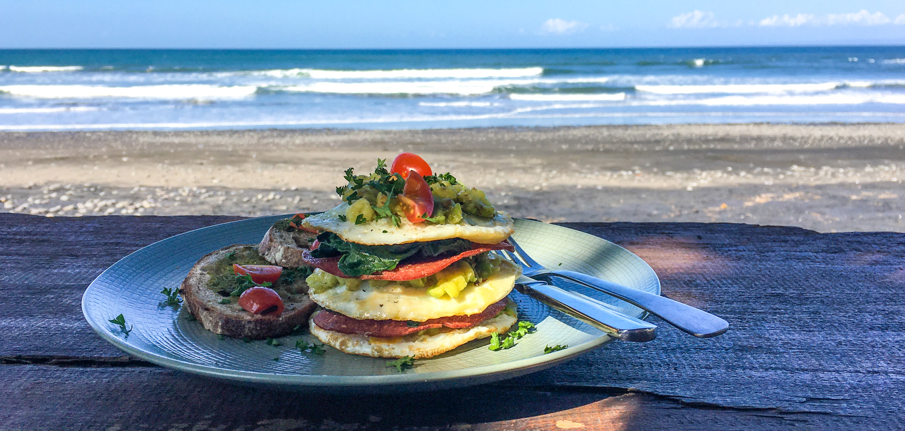 A plated meal photographed near the sea in West Bali’s Medewi dining guide; not a verified recipe from the cookbook.