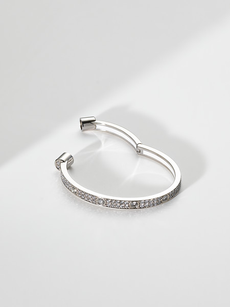 Side view detail close-up of 4.9ct pavé bracelet handcrafted in solid 18k white gold with white enamel interior and integrated magnetic clasp