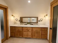 Natural wood double vanity with brass fixtures – Cobleigh renovation, Eagle Point, Oregon