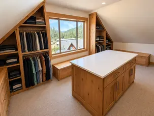 Custom wood closet built-ins beneath sloped ceiling – Cobleigh renovation, Eagle Point, Oregon