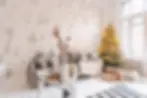 A clean and organized living room with a decorated Christmas tree and festive decor for holiday cleaning