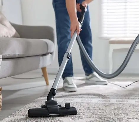 A professional carpet cleaning machine on a living room rug