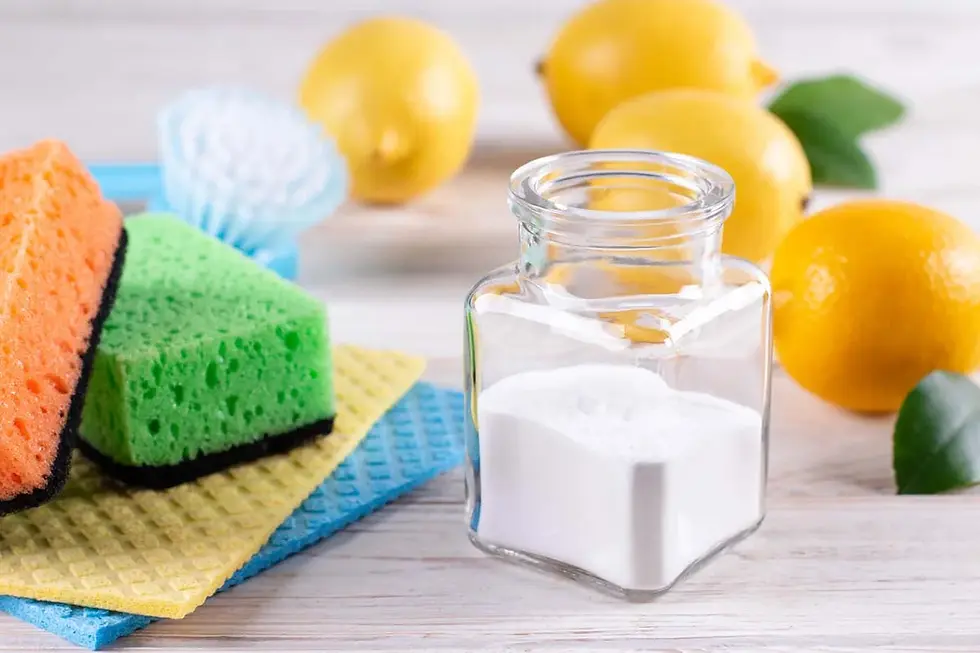 Natural cleaning supplies like baking soda and lemon used as a diy dishwasher cleaner without vinegar alternatives