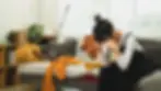 A person looking stressed in a cluttered living room needing a quick clean