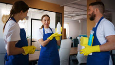 Professional cleaning team working in a modern living room and kitchen during winter