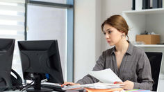 Business owner reviewing an office cleaning contract at a desk