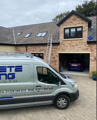 Complete Roofing van parked in front of a house, visible text on the van.