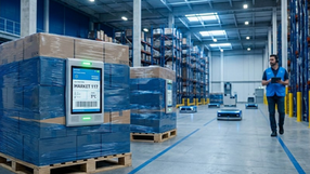 A modern supply chain environment illustrating tech-to-business outcomes. The image shows a smart sensor on a grocery pallet used for real-time inventory tracking and spoilage prevention, representing how technical infrastructure creates predictable business margins and scalability.